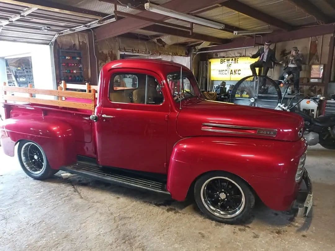 Restored cherry-red Ford pickup in the Old Guys Garage bay